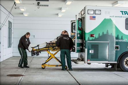 EMT's unload a patient from a DHART ambulance
